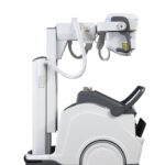Dental x-ray machine mounted on a vertical stand with an articulating arm and a wheeled base for mobility.