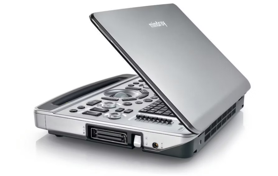 Open silver portable scanner/fax with a raised lid showing the illuminated control panel and front card slot, ready for scanning or copying lines of text.