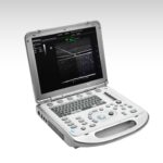 Portable ultrasound machine with keyboard and screen showing ultrasound images and controls on a lab-style base. Reflects a laptop-like medical scanner.