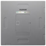 Back panel of a fujifilm device with the battery compartment door open, showing the small door and status lights above it.