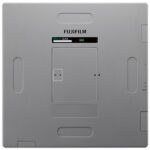 Back panel of a fujifilm device featuring a central battery/card compartment door and a small status display above it. Two vertical grip recesses are visible on the sides.